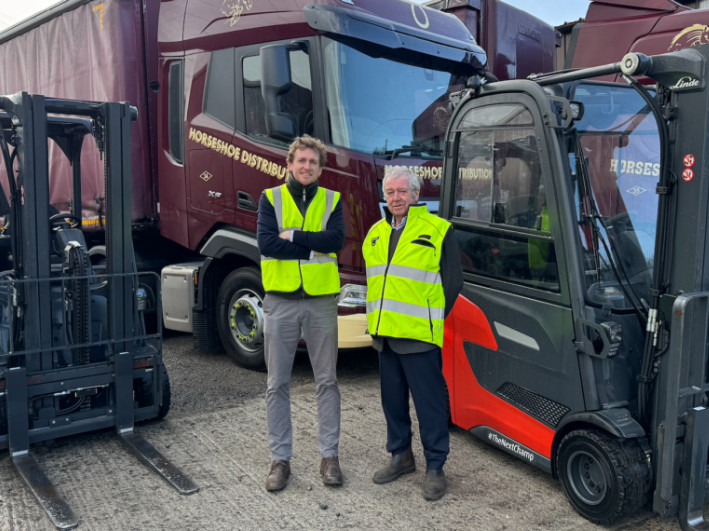 Men stood in front of forklift trucks and lorries with the Argo Feeds logo